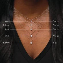 Necklace with diamond pendants on a person wearing a black top, showing size measurements.